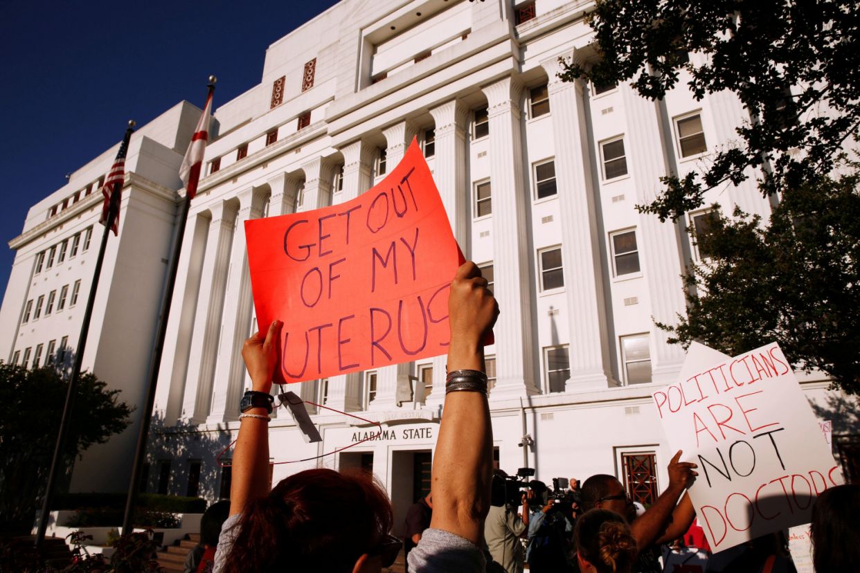 A person holds a sign 