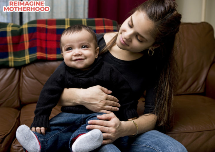 Photo of a person holding a baby.