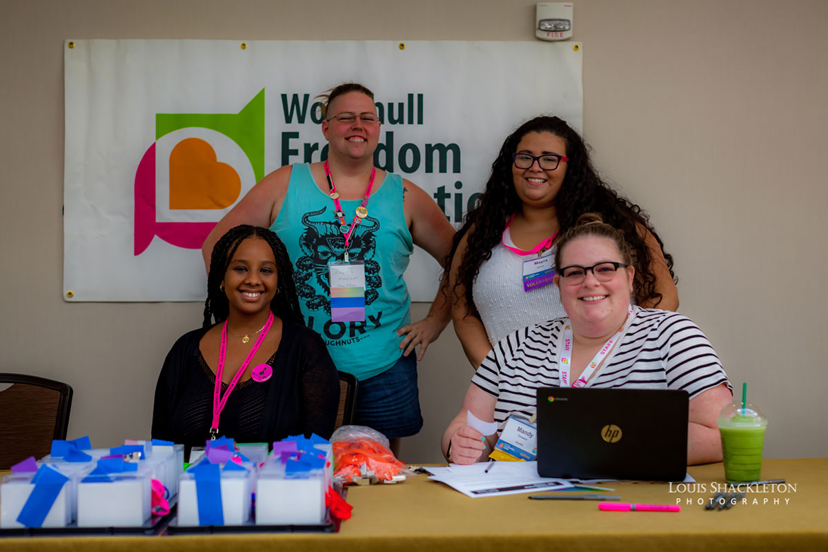 Photo of Summit Volunteers at the Registration Desk