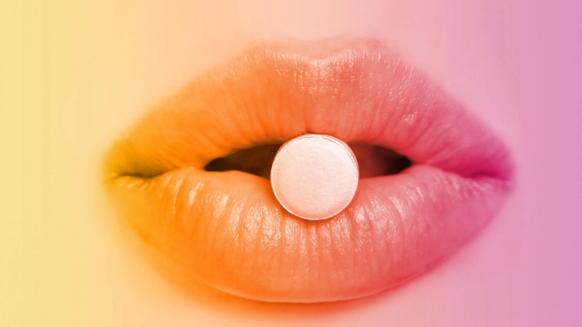 pair of lips pursed to hold a pill.