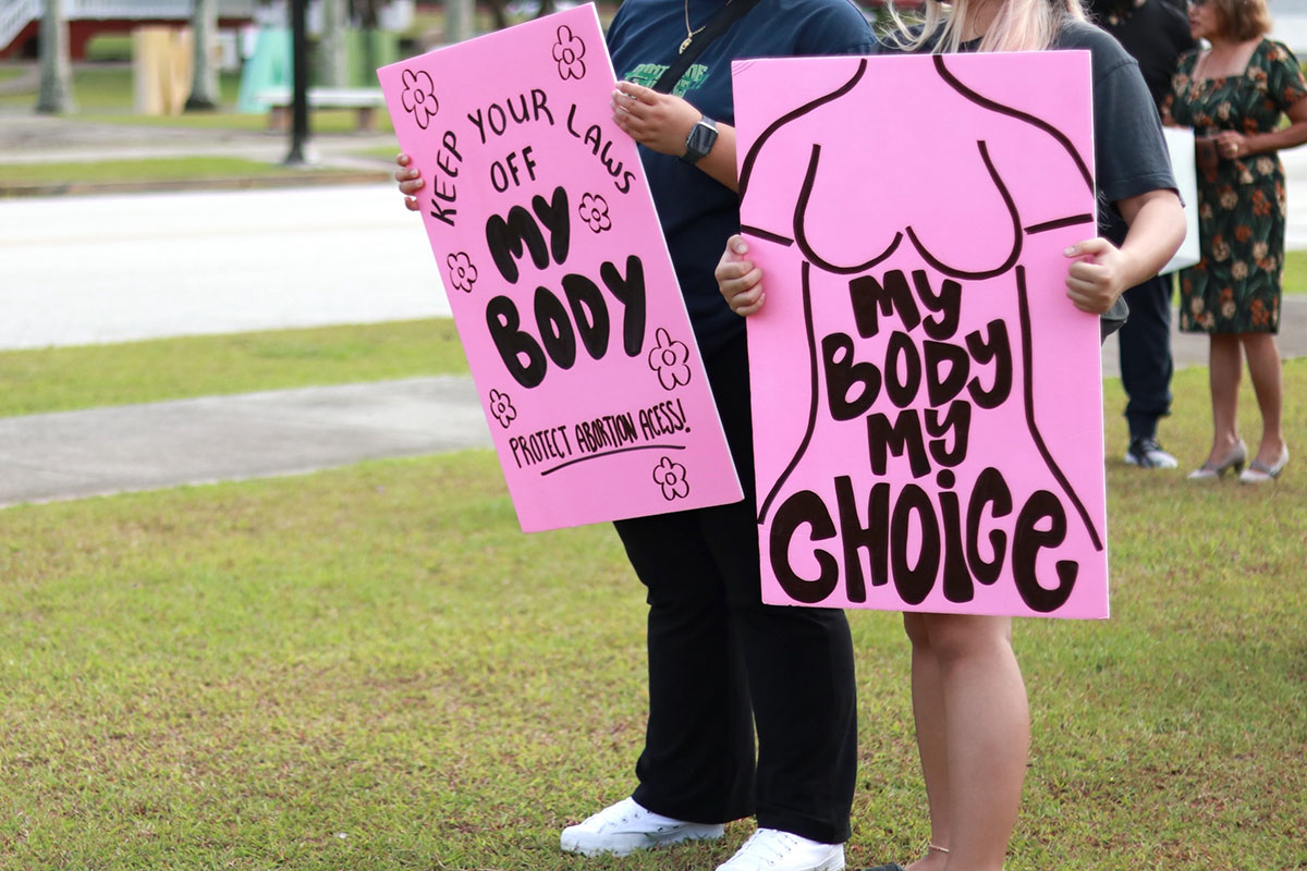 Photo of people holding protest signs.