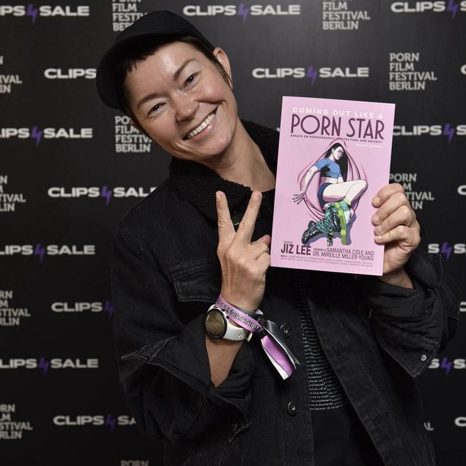 Photo of Jiz Lee holding a book