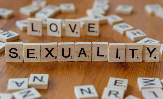 Photo of Scrabble tiles spelling love and sexuality.
